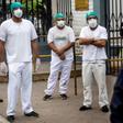 Health workers protest about the lack of protective medical equipment outside the Hipolito Unanue hospital in Lima