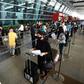 At New Delhi airport, hundreds of people anxious to get home but apprehensive about the risks queued from before dawn