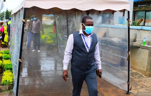 KNH CEO Dr Evanson Kamui goes through a sanitization booth donated by Sonko Rescue Team