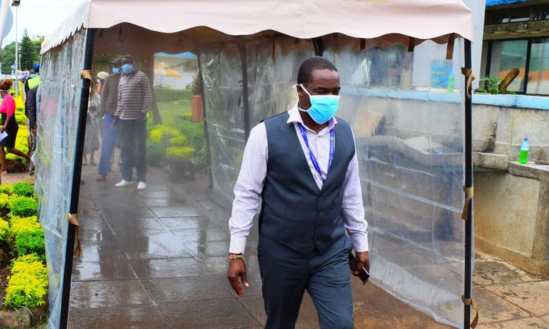 KNH CEO Dr Evanson Kamui goes through a sanitization booth donated by Sonko Rescue Team