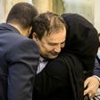 Iranian doctor Majid Taheri, who had been detained in the United States for 16 months, hugs his children upon his arrival at Tehran's Imam Khomeini International Airport on Monday
