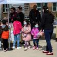 Children pick up free lunch in Arlington, Virginia on March 16, 2020, after schools closed due to coronavirus. Disrupted school lunch programs could be a factor in alarming rises in hunger among US children since the outbreak began, the study says