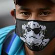 A Venezuelan migrant wears a face mask as he waits to board a bus to voluntarily return to his country because of the novel coronavirus in Cali, Colombia, on April 14