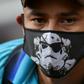 A Venezuelan migrant wears a face mask as he waits to board a bus to voluntarily return to his country because of the novel coronavirus in Cali, Colombia, on April 14