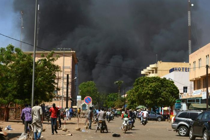 Smoke rises from the Burkinabe capital Ouagadougou from a jihadist attack in March 2018. Eight soldiers and eight assailants died, according to an official toll