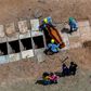 An aerial view of a burial is seen at the Bom Jardim cemetery, the largest public cemetery in Fortaleza, Ceara state, Brazil on May 7, 2020, as many of the burials were of people who were confirmed or suspected to have died from COVID-19