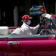 The driver of a vintage American car wears a face mask while taking tourists around Havana -- but Cuba is to close to visitors over the coronavirus outbreak