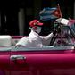 The driver of a vintage American car wears a face mask while taking tourists around Havana -- but Cuba is to close to visitors over the coronavirus outbreak