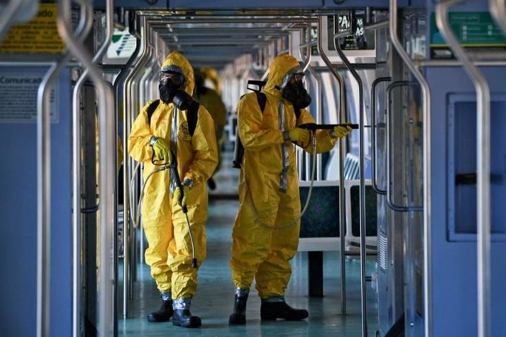 Brazilian soldiers disinfect a train wagon at the central station in Rio de Janeiro