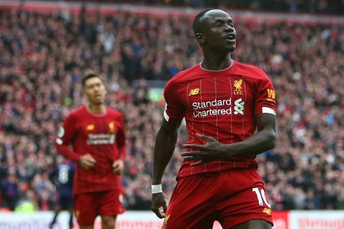 Liverpool's Senegalese striker Sadio Mane (R) has donated $50000 US dollars to the Coronavirus fight in gis country