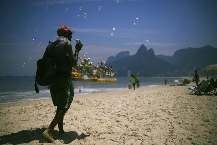 Brazilian beach vendor Marco Conceicao offers bubble toys for sale on Rio de Janeiro's Ipanema on March 19, 2020