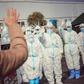 Medical staff members wave to a recovered patient at a makeshift hospital for the COVID-19 coronavirus patients in Wuhan