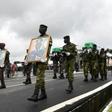 Ivory Coast soldiers carry coffins and pictures of their comrades killed in a brazen jihadist attack last month