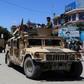 Afghan security forces sit in a Humvee vehicle on May 19 amid fighting between Taliban militants and Afghan security forces in Kunduz