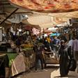 Iraqis walk through a fresh produce market in the southern Iraqi city of Basra as some lockdown restrictions imposed during the novel coronavirus pandemic have been eased