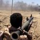 A southern separatist fighter watches as a military vehicle belonging to Yemen's Saudi-backed government forces burns during clashes in Abyan province on May 11