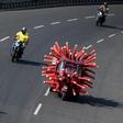 A health worker drives an auto-rickshaw decorated as a coronavirus model to raise awareness about the pandemic in Chennai, India