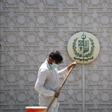 A man sweeps in front of the main gate of the Pakistan High Commission in New Delhi