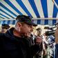 A cameraman speaks with a Cyprus police officer during the protest in the divided capital Nicosia