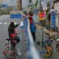 Barriers to stop the spread of the coronavirus in Wuhan have divided communities