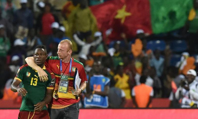 Midfielder Christian Bassogog (L) and assistant coach Sven Vandenbroeck celebrate after Cameroon won the 2017 Africa Cup of Nations final against Egypt in Libreville