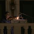 Members of Qatar's philharmonic orchestra perform from their balconies one last time before Ramadan in Qatar's Qanat Quartier, a part of Doha's man-made Pearl island