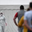 Workers queue for a coronavirus test at the Westfleisch meat processing company in Hamm as all require a test after a spike in cases at their slaughterhouse