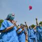 Petals fell on to the upturned faces of medical personnel clad in protective gear