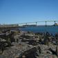 Cars cross over the International Bridge from the US state of Maine (left) on the US-Canada border, which the US is closing to "non-essential" traffic