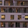 Passengers of the coronavirus-stricken Australian liner Greg Mortimer display a sheet reading "Thank You Uruguay" as the cruise ship arrives at Montevideo's port on April 10, 2020