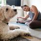 Singaporean Alison Yuen takes an online fitness class in her Hong Kong home, watched by her golden labradoodle Whelan