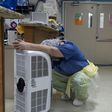 A medical worker rests in front of a fan in the COVID-19 intensive care unit at United Memorial Medical Center in Houston, Texas