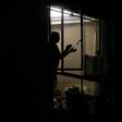 A woman in Buenos Aires, Argentina claps her hands to express gratitude to health workers, a nightly tradition during the "preventative and compulsory" lockdown