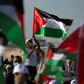 Palestinians wearing masks attend a rally to protest against Israel's plan to annex parts of the occupied West Bank, in Jericho on June 22