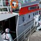 Medics help a sick passenger from an Australian liner off a Uruguay navy launch in Montevideo, on April 3, 2020