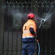 A worker cleans the entrance to St Patrick's Cathedral in Melbourne after it was vandalised following Cardinal George Pell's release from prison