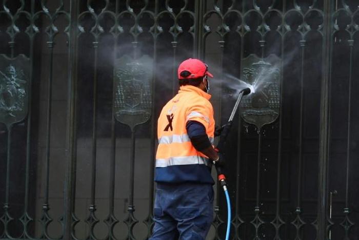 A worker cleans the entrance to St Patrick's Cathedral in Melbourne after it was vandalised following Cardinal George Pell's release from prison