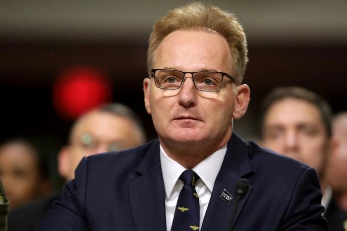 The aircraft carrier USS Theodore Roosevelt docked in Guam as authorities try to counter a coronavirus outbreak that has infected at least 585 of the ship's 4,800 crew and left one saiilor dead on Monday
