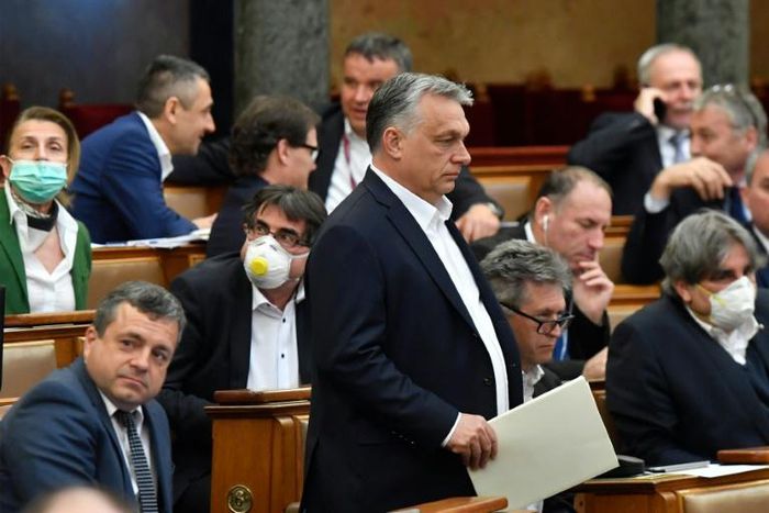 Hungarian Prime Minister Viktor Orban (centre) has said that ruling by decree allowed him to respond quickly and effectively during the virus emergency