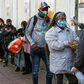 A worker checks the temperature of a customer outside a supermarket in Valparaiso on June 12 as the city went under quarantine