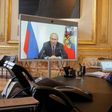 French President Emmanuel Macron talks to Russian President Vladimir Putin during a videoconference on June 26 at the Elysee Palace in Paris