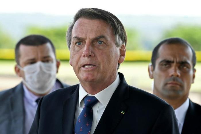 Brazilian President Jair Bolsonaro, pictured on March 20, has sparked outrage among critics with a national address condemning "scorched-earth" containment measures such as closing businesses and confining people