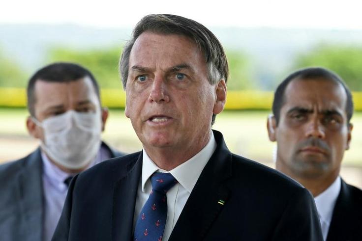 Brazilian President Jair Bolsonaro, pictured on March 20, has sparked outrage among critics with a national address condemning "scorched-earth" containment measures such as closing businesses and confining people