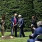 US President Donald Trump and Vice President Mike Pence, accompanied by their wives, plant a tree at the White House to mark Earth Day despite their frequent criticism of environmentalists