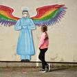 A girl looks at a mural by artist Rachel List paying tribute to NHS staff in Britain