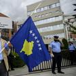 A man holds a Kosovo flag in a show of support for ousted leftist prime minister left-wing leader Albin Kurti
