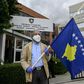 A man holds a Kosovo flag in a show of support for ousted leftist prime minister left-wing leader Albin Kurti