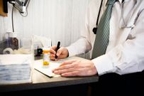 doctor writing prescription
