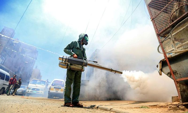 A worker fumigates a neighbourhood in Yemen's Huthi rebel-held capital Sanaa as part of safety precautions during the coronavirus pandemic on March 23