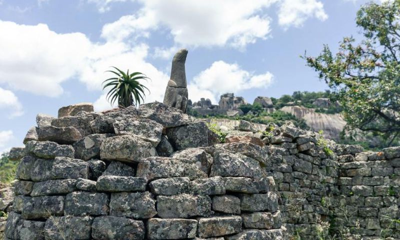 A carved bird in standstone temporarily left an on-site museum to take up its rightful place in the Great Zimbabwe ruins, symbol of an African culture